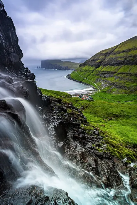 Framed Print : Cloudy sky over a scenic waterfall in summer, Tjornuvik, Streymoy Island, Faroe Islands Framed Print : Cloudy sky over a scenic waterfall in summer, Tjornuvik, Streymoy Island, Faroe Islands
