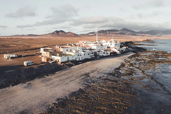 Coastal village of El Puertito and wind turbine, close to Punta de Jandia, Fuerteventura