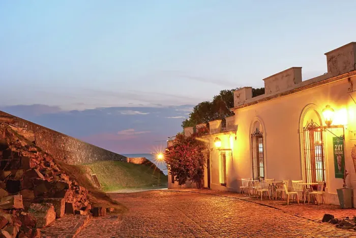 Framed Print : A cobbled street and the Bastion of San Miguel fortified wall at twilight, with the Rio de la Plata river in the background, Colonia del Sacramento, Uruguay Framed Print : A cobbled street and the Bastion of San Miguel fortified wall at twilight, with the Rio de la Plata river in the background, Colonia del Sacramento, Uruguay