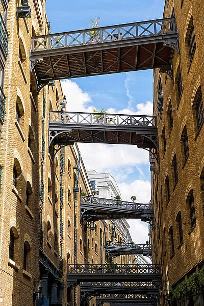 The cobbled street Shad Thames, behind Butler's Wharf on the River Thames, known for its renovated warehouse /  apartment and restored overhead bridges and walkways, London, England