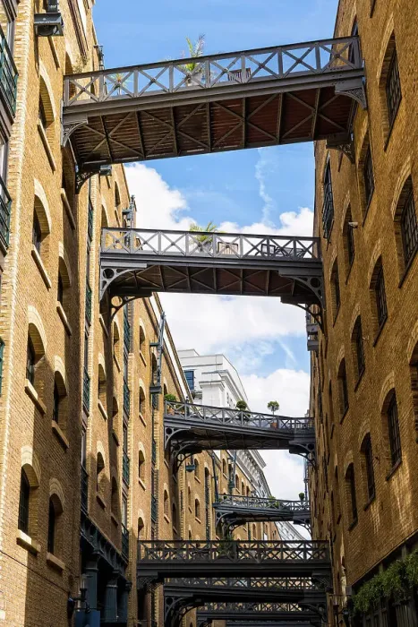 Framed Print : The cobbled street Shad Thames, behind Butler's Wharf on the River Thames, known for its renovated warehouse /  apartment and restored overhead bridges and walkways, London, England