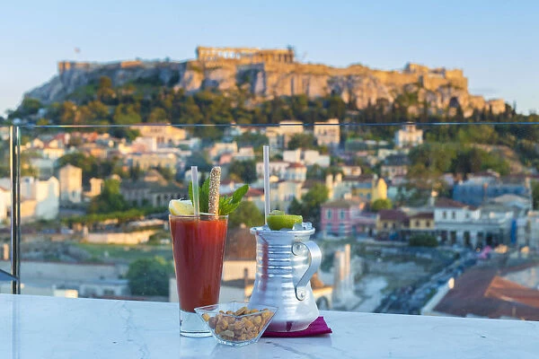 Cocktails on rooftop bar and the Acropolis in the background, Athens, Greece