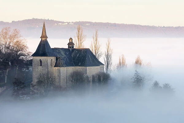 Colla giale Notre Dame et St Pantala on de Turenne in the mist at sunset, Correze