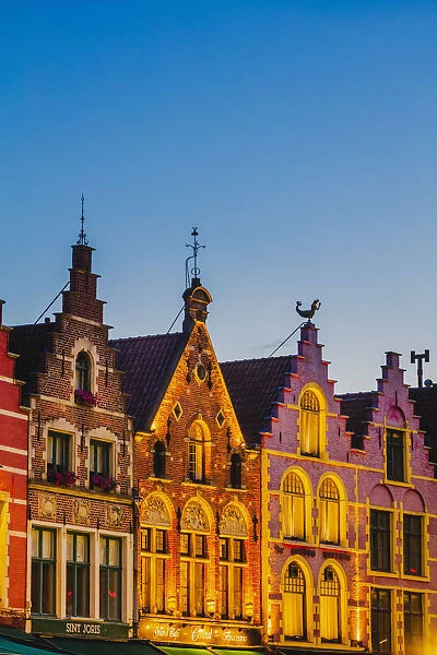 Detail of the colored houses facades in Markt Square in Bruges by night, Belgium