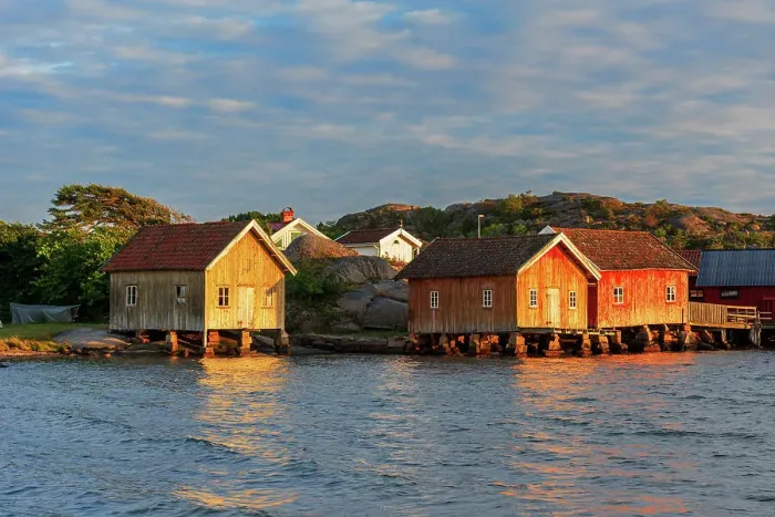 Framed Print : Colored and old fishing houses lit by sunset, Bohuslan, Sweden, Scandinavia Framed Print : Colored and old fishing houses lit by sunset, Bohuslan, Sweden, Scandinavia
