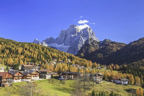 Colorful autumn larches in Selva of Cadore with Mount Pelmo in the background. Dolomites