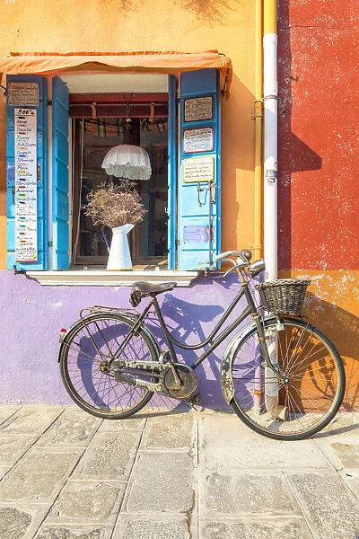 Colorful house facade in Burano island with old bike, Burano, Venice, Veneto, Italy