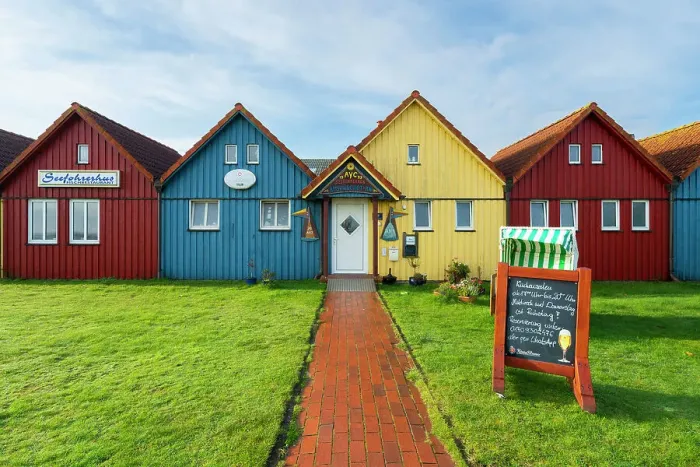 Framed Print : Colorful houses of Seefohrerhus restaurant, Wittdun harbor, Amrum island, Nordfriesland, Schleswig-Holstein, Germany Framed Print : Colorful houses of Seefohrerhus restaurant, Wittdun harbor, Amrum island, Nordfriesland, Schleswig-Holstein, Germany