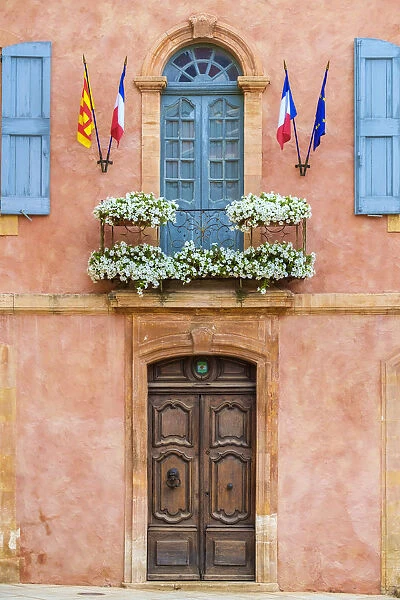 Colorful ochre colored faAzade of Mairie (mayors office) in Roussillon, Vaucluse
