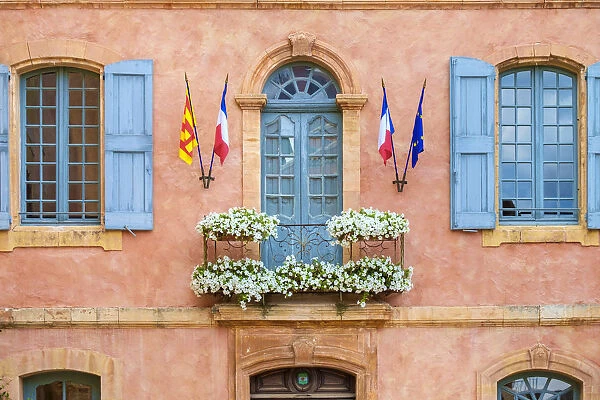 Colorful ochre colored faazade of Mairie (mayors office) in Roussillon, Vaucluse