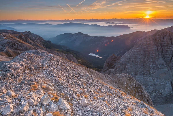 Colorful sky at sunrise as seen from a summit in the mountains of the Brenta Dolomites