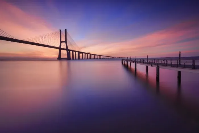 Framed Print : The colors of dawn on Vasco da Gama Bridge that spans the Tagus River in Parque das NaA'A§A'Aµes Lisbon Portugal Europe