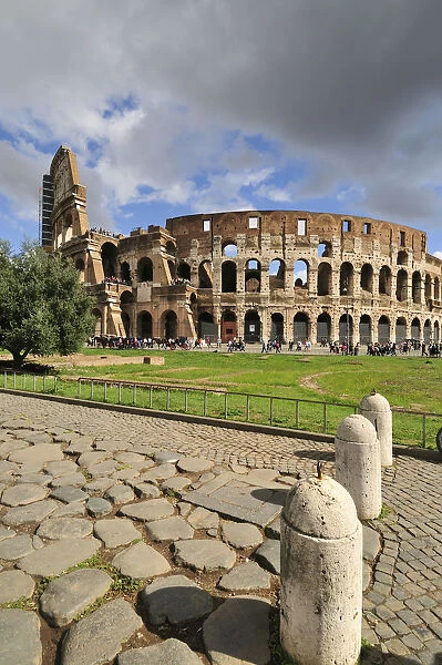 The Colosseum or Coliseum and a roman stone pavement on the foreground
