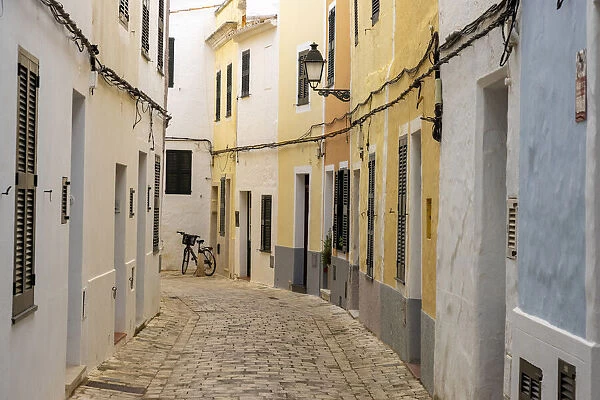 Colourful buildings line a narrow street in the old town of Ciutadella, Ciudadela