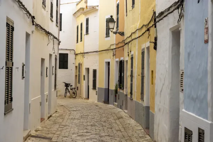 Framed Print : Colourful buildings line a narrow street in the old town of Ciutadella, Ciudadela Framed Print : Colourful buildings line a narrow street in the old town of Ciutadella, Ciudadela