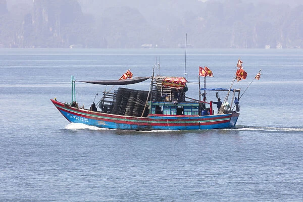 Colourful fishing boat with flags, Halong Bay, Quang Ninh Province, North-East Vietnam