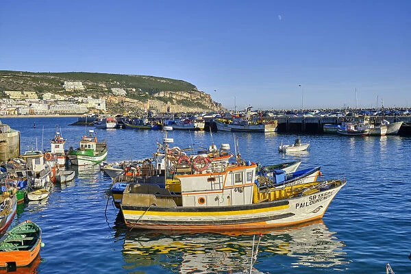 Colourful fishing boats at the Sesimbra fishing harbour. Portugal