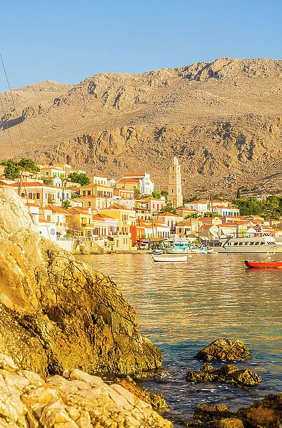 The colourful harbour and Saint Nicholas church in the background, Halki, Chalki, Dodecanese Islands, Greece