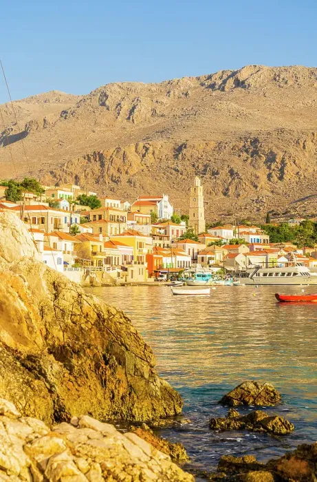 Framed Print : The colourful harbour and Saint Nicholas church in the background, Halki, Chalki, Dodecanese Islands, Greece Framed Print : The colourful harbour and Saint Nicholas church in the background, Halki, Chalki, Dodecanese Islands, Greece
