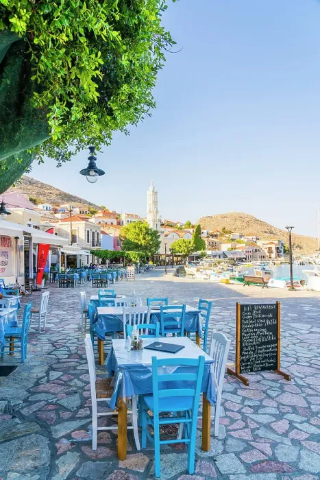 Framed Print : The colourful harbour and Saint Nicholas church in the background, Halki, Chalki, Dodecanese Islands, Greece Framed Print : The colourful harbour and Saint Nicholas church in the background, Halki, Chalki, Dodecanese Islands, Greece