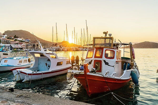 The colourful harbourat sunrise, in Halki, Chalki, Dodecanese Islands, Greece
