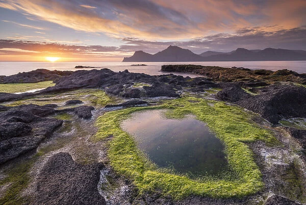 Colourful summer sunrise from the rocky shores of Gjogv on the island of Eysturoy