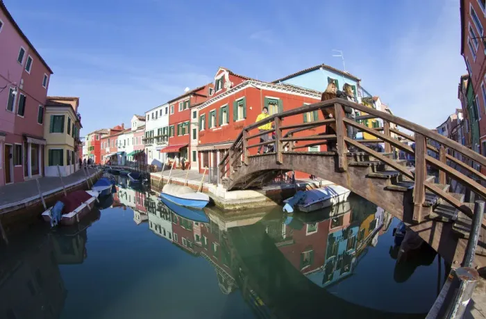 Framed Print : The many colours of the typical houses of Burano are reflected into the green waters Framed Print : The many colours of the typical houses of Burano are reflected into the green waters