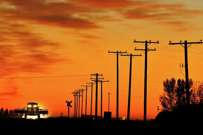 Framed Print : Combine moving down the road at sunset Tuxford, Saskatchewan, Canada