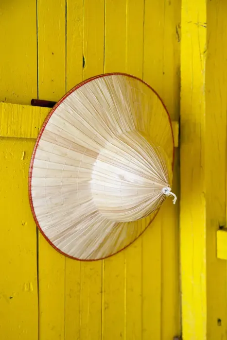 Framed Print : Conical hat hanging on a yellow wall, Halong Bay, Vietnam Framed Print : Conical hat hanging on a yellow wall, Halong Bay, Vietnam