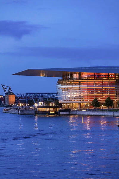 Copenhagen Opera House reflecting in the canal by night, Denmark