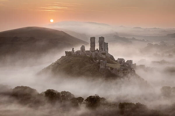 Corfe Castle at dawn surrounded by mist, Dorset, England