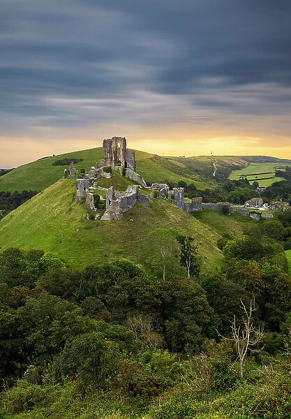 Corfe Castle portrayed from hills at sunrise, Corfe Castle, Purbeck, Dorset, England, United Kingdom