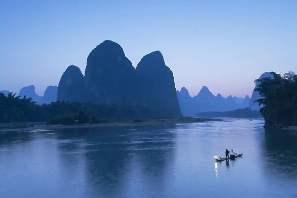 Cormorant fisherman on Li River at dusk, Xingping, Yangshuo, Guangxi, China