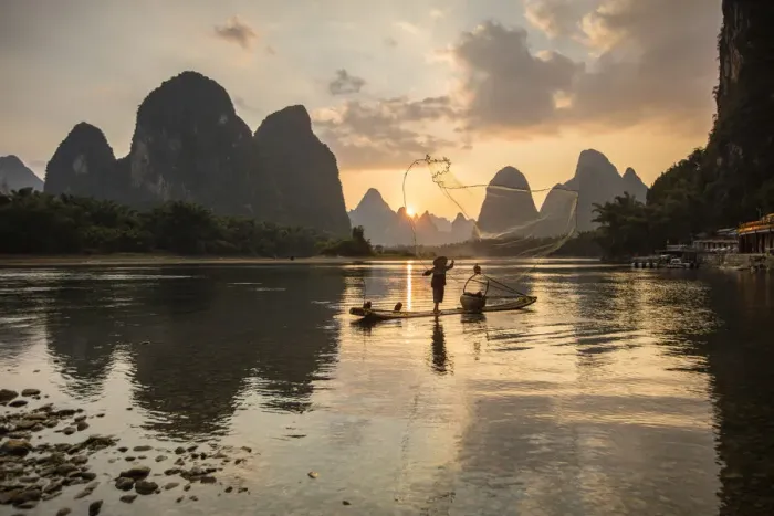 Framed Print : Cormorant fisherman throwing net on Li River at dawn, Xingping, Yangshuo, Guangxi, China Framed Print : Cormorant fisherman throwing net on Li River at dawn, Xingping, Yangshuo, Guangxi, China