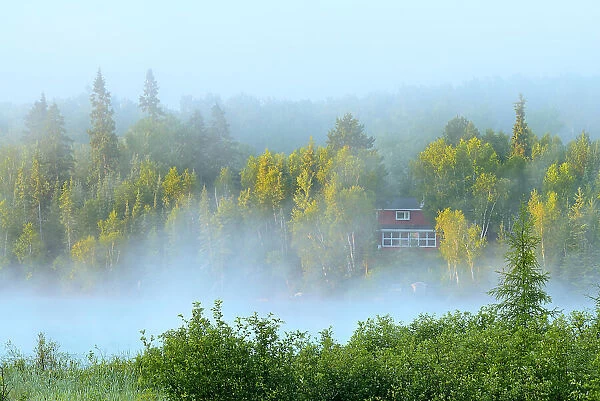 Cottage in morning fog on Longbow Lake Kenora Ontario, Canada