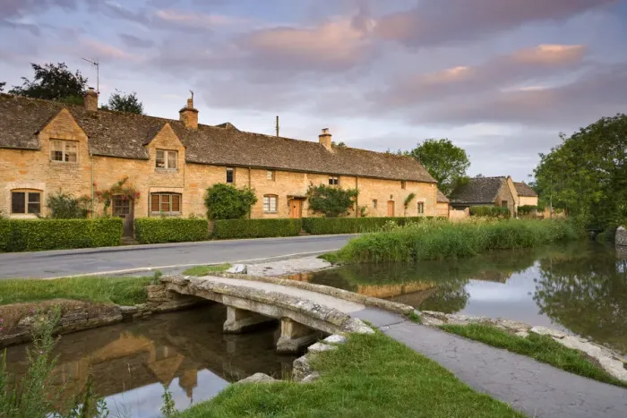 Framed Print : Cottages and stone footbridge in the Cotswolds village of Lower Slaughter, Gloucestershire Framed Print : Cottages and stone footbridge in the Cotswolds village of Lower Slaughter, Gloucestershire