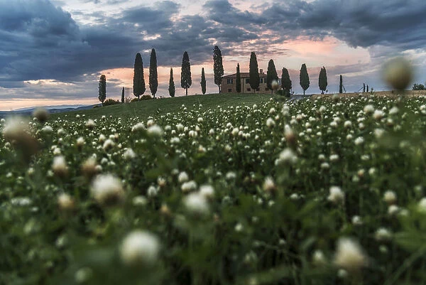 Countryhouse near Pienza during a cloudy sunset in summer, Val d Orcia, Tuscany