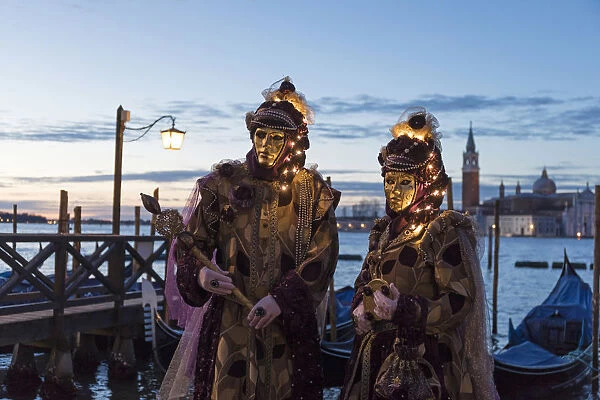 Couple with illuminated masks at Carnival time, Piazza San Marco (St. Marks Square)