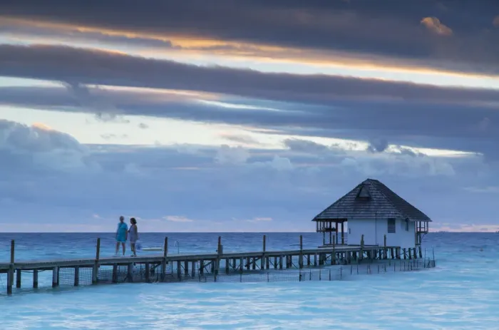 Framed Print : Couple on jetty at sunset, Fakarava, Tuamotu Islands, French Polynesia Framed Print : Couple on jetty at sunset, Fakarava, Tuamotu Islands, French Polynesia