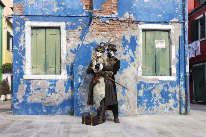 Framed Print : Couple in steampunk costumes in front of old blue house at Carnival time, Burano Island Framed Print : Couple in steampunk costumes in front of old blue house at Carnival time, Burano Island