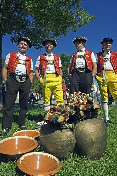 Cowbell ringers in traditional alpine costume at the