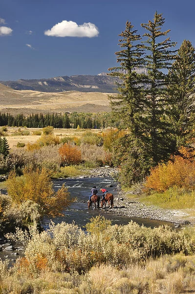 Cowboys along Wind River, near Dubois, Wyoming, USA