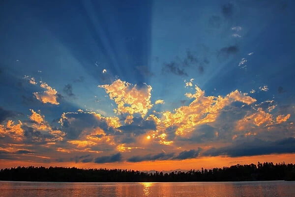 Crepuscular rays (God rays) on Star Lake Whiteshell Provincial Park, Manitoba, Canada