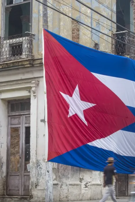Framed Print : Cuba, Huge Cuban flag hanging across buildings in a street in Santa Clara, after