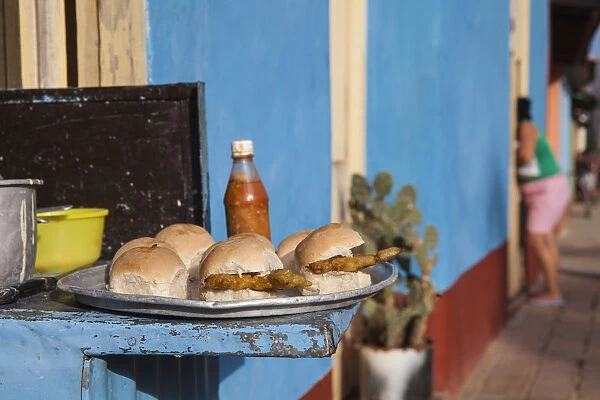 Cuba, Trinidad, Colourful street in historical center, Burgers being sold from house