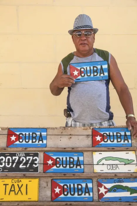 Framed Print : Cuba, Trinidad, Man selling Cuban car number plates
