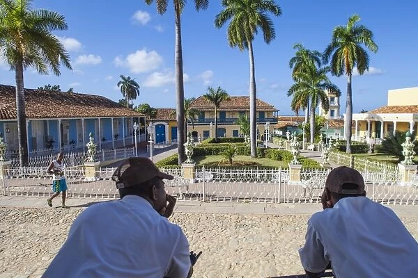 Cuba, Trinidad, Two Security guards look across Plaza Mayor