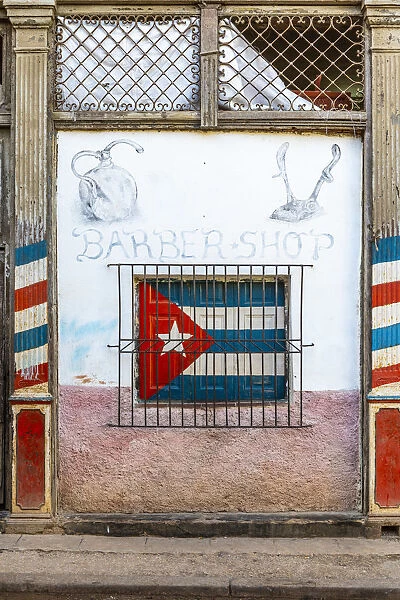 Cuban flag painted on the window of a barber shop in La Habana Vieja (Old Town), Havana
