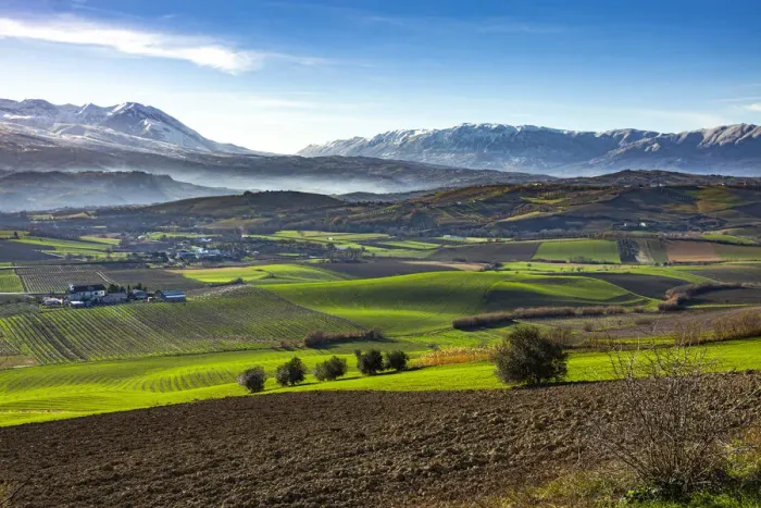 Framed Print : Cultivated fields and small villages. In the background Framed Print : Cultivated fields and small villages. In the background