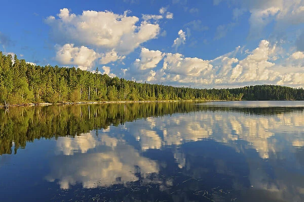 Cumulus clouds reflected in Lac Seul Ear Falls Ontario, Canada
